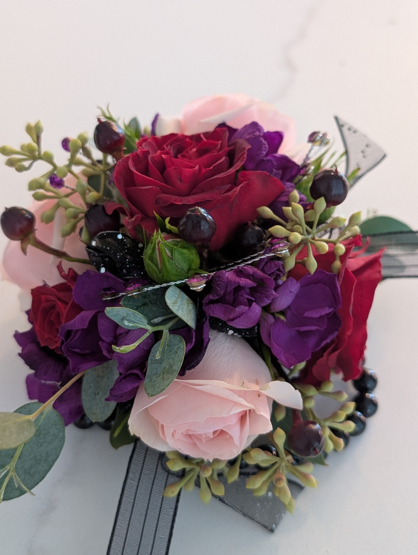 Red and purple rose corsage